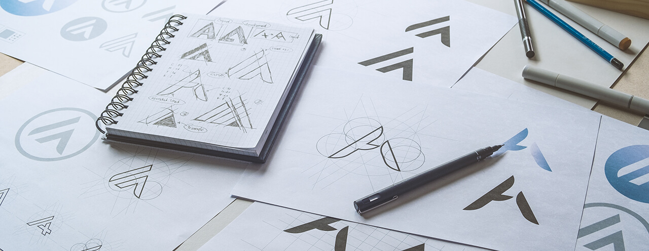 Graphic designer drawing logo concepts from preliminary sketchs.